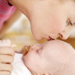 Woman Kissing the Top of a Baby’s Head (3-6 Months)